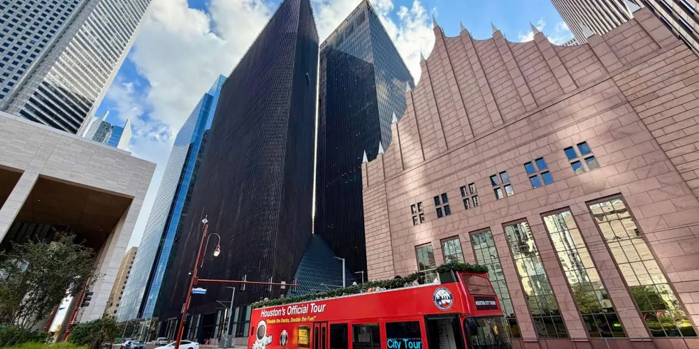 Hop-on hop-off city tour bus among downtown Houston's skyscrapers