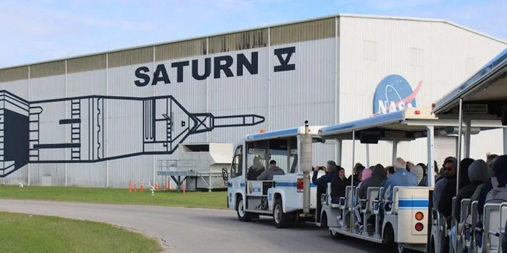 NASA tram passing the Saturn V building at Space Center Houston