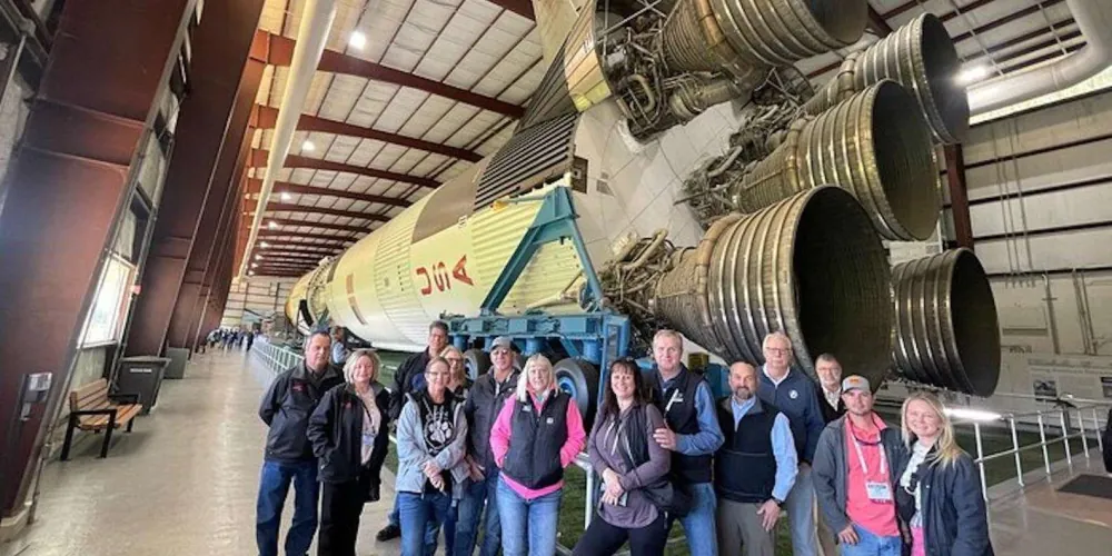 Tour group beneath the Saturn V rocket engines in Rocket Park